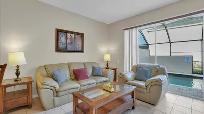 a living room with a couch and a table at 2326 Silver Palm in Kissimmee