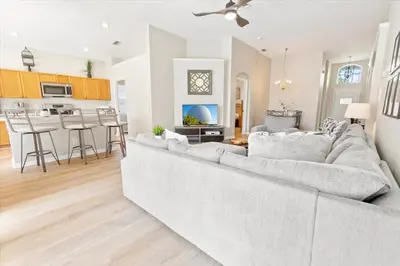 a living room with a large couch and a kitchen at 2209 Wyndham Palms in Kissimmee