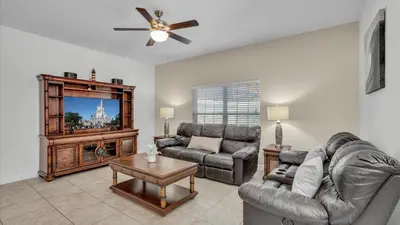 a living room with a couch and a tv at 8967 Cat Palm in Kissimmee