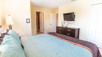 a bedroom with a bed and a flat screen tv at 8951 Coco Palm in Kissimmee