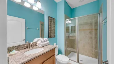 a bathroom with a sink and a shower and a toilet at 8946 Cuban Palm in Kissimmee