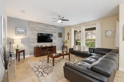 a living room with a couch and a flat screen tv at 8949 Cuban Palm in Kissimmee