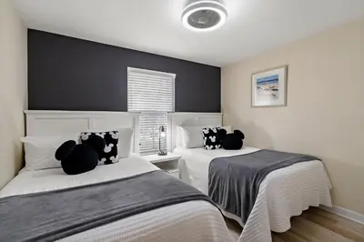 a bedroom with two beds with stuffed cats on them at 8949 Cuban Palm in Kissimmee
