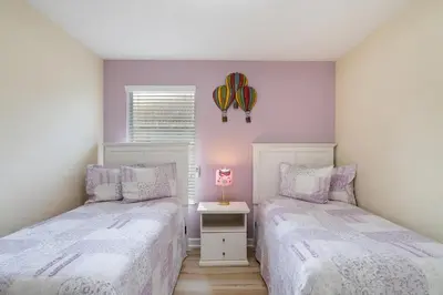a bedroom with two beds and a window at 8949 Cuban Palm in Kissimmee