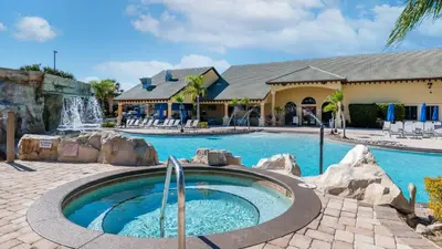a swimming pool with a waterfall in a resort at 8949 Cuban Palm in Kissimmee