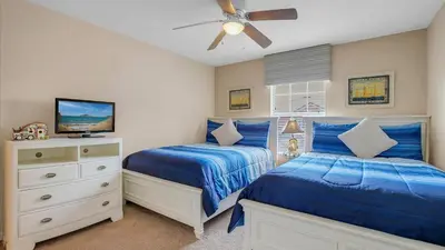 a bedroom with two beds and a ceiling fan at 8968 Cuban Palm in Kissimmee