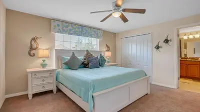 a bedroom with a bed and a ceiling fan at 8968 Cuban Palm in Kissimmee