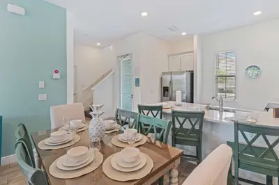 a dining room and kitchen with a table and chairs at 8000 Lost Shaker Lane in Orlando