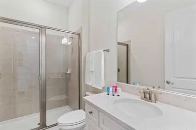 a bathroom with a toilet and a sink and a shower at 8000 Lost Shaker Lane in Orlando