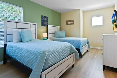 two beds in a bedroom with green walls at 2638 Dinville in Orlando