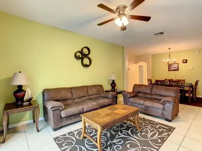 a living room with two couches and a ceiling fan at Beautiful Windsor Palms 4 Bed South Facing Pool villa in Kissimmee