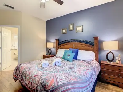 a bedroom with a large bed with blue walls at Beautiful Windsor Palms 4 Bed South Facing Pool villa in Kissimmee