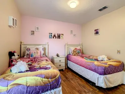 two beds with stuffed animals on them in a room at Beautiful Windsor Palms 4 Bed South Facing Pool villa in Kissimmee