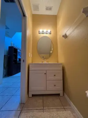 a bathroom with a sink and a mirror at Villa Madiera 6 bedroom huge house in Kissimmee