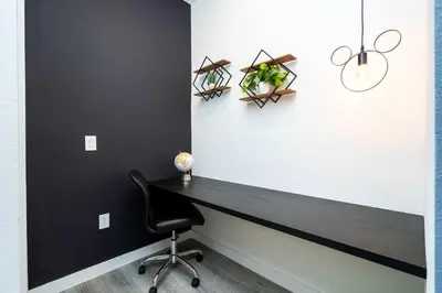 a black desk in a room with a chair at Marvelous 3Bd Close to Disney w GameRoom at The Hub 3409 in Kissimmee