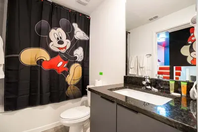 a bathroom with a mickey mouse shower curtain at Marvelous 3Bd Close to Disney w GameRoom at The Hub 3409 in Kissimmee