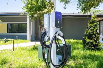 a gas pump in the grass in front of a house at Marvelous 3Bd Close to Disney w GameRoom at The Hub 3409 in Kissimmee
