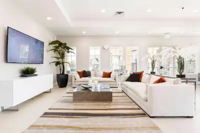 a living room with two white couches and a tv at Gorgeous Dream Villa 5 min to Disney in Orlando