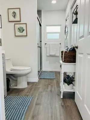 a white bathroom with a toilet and a sink at Roy's guest house in Orlando