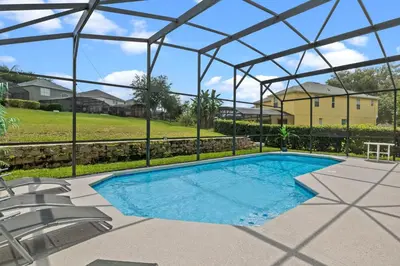 a swimming pool with a pergola and chairs at Be-Our-Guest Home! 15 mins to Disney! in Kissimmee