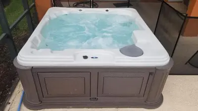a jacuzzi tub sitting in a yard at Be-Our-Guest Home! 15 mins to Disney! in Kissimmee