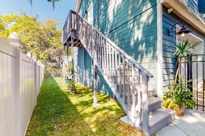 a stairway leading up to a blue house at Dog-Friendly Apt with Fenced Yard in Winter Park in Orlando