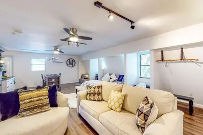 a living room with two couches and a kitchen at Dog-Friendly Apt with Fenced Yard in Winter Park in Orlando