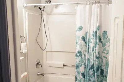 a bathroom with a shower with a shower curtain at Sanford Country Escape Fire Pit, Yard and Wildlife! in Sanford