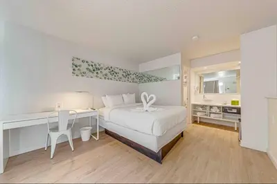 a bedroom with a bed and a desk with a desk at Travel Lodge by Wyndham 10 min from Disney in Kissimmee