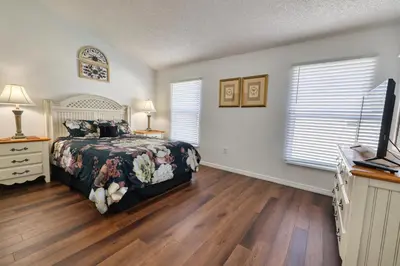 a bedroom with a bed and a television in it at Clear Creek 3 Bedroom Home Private Pool 15 Min to Disney in Orlando