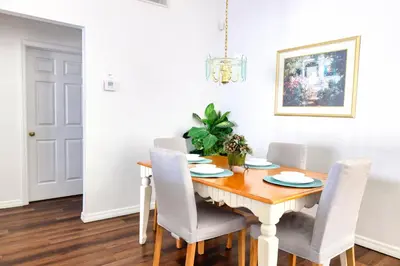 a dining room with a wooden table and chairs at Clear Creek 3 Bedroom Home Private Pool 15 Min to Disney in Orlando