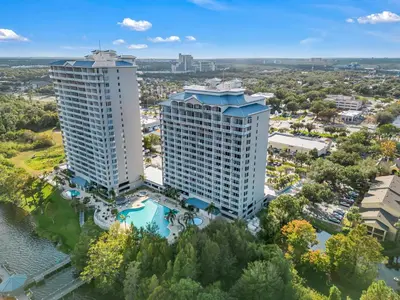 an aerial view of two tall buildings next to a river at 2BR condo minutes to Disney Springs in Orlando