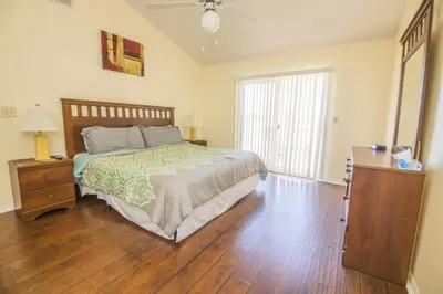 a bedroom with a bed and a dresser and a window at Sweetwater Club 3 Bedroom Condo Resort Pool 9 Miles to Disney in Kissimmee