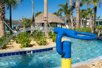 a pool with a water slide in a resort at 2681 Stunning home perfect for your family in Kissimmee