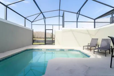 an indoor swimming pool with a glass ceiling at Luxurious Home w Theme Beds & Private Pool in Kissimmee