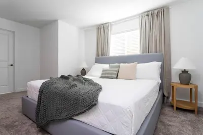 a bedroom with a bed and a window at Luxurious Home w Theme Beds & Private Pool in Kissimmee