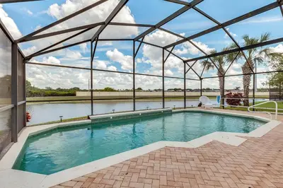 a swimming pool in a building with a glass roof at 4 bedrooms pool home with water view and short drive from Disney in Kissimmee