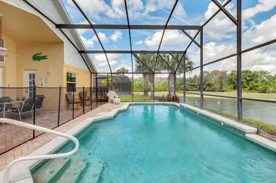 a swimming pool in a house with a glass ceiling at 4 bedrooms pool home with water view and short drive from Disney in Kissimmee