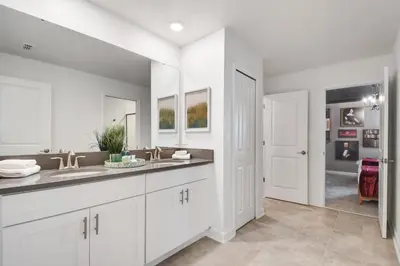 a white bathroom with a sink and a mirror at Storey Lake 10BR Lakeview Home Pool/SPA Game Room in Kissimmee