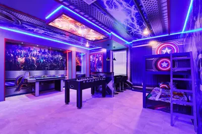 a room with a ping pong table in a room with purple lights at Storey Lake 10BR Lakeview Home Pool/SPA Game Room in Kissimmee