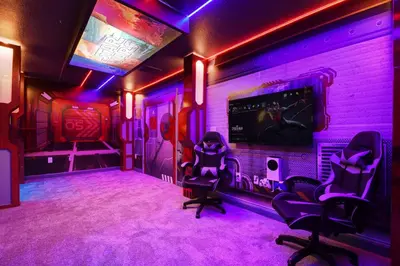 a room with purple lights and two chairs and a tv at Storey Lake 10BR Lakeview Home Pool/SPA Game Room in Kissimmee