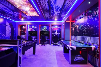 a gaming room with purple lighting and ping pong tables at Storey Lake 10BR Lakeview Home Pool/SPA Game Room in Kissimmee