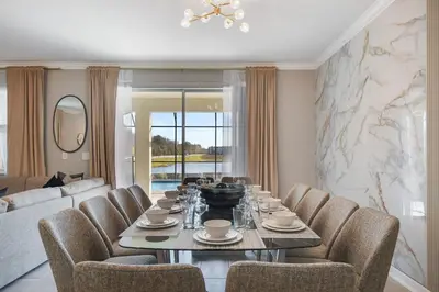 a dining room with a table and chairs at Storey Lake 10BR Lakeview Home Pool/SPA Game Room in Kissimmee