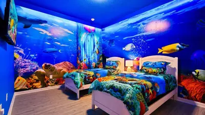 a room with two beds in front of an aquarium at Opulent Retreat, Pool & Lake View, Near Parks in Kissimmee