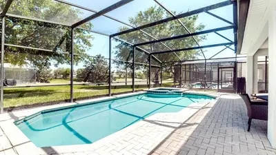 a swimming pool in a house with a glass house at Windsor Hills 7BR Villa Pool SPA Disney Greenview in Orlando