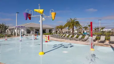 a pool with a water park with a basketball hoop at Family Reunion 10BR Villa Pool/SPA Near Disney! in Kissimmee