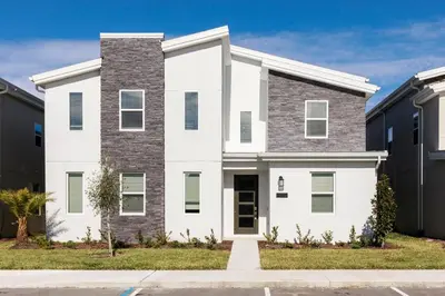 a white and gray house with a driveway at Family Reunion 10BR Villa Pool/SPA Near Disney! in Kissimmee