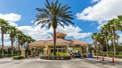 a palm tree in front of a building at Windsor Hills 5br Private Pool, Near Disney in Orlando