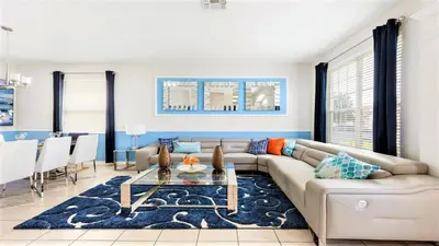 a living room with a couch and a table at Home with Lakeview Close to Disney w Pool in Orlando