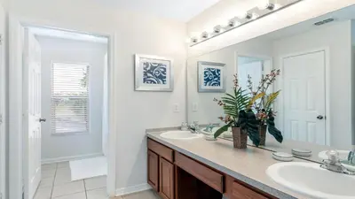 a bathroom with a sink and a mirror at Home with Lakeview Close to Disney w Pool in Orlando